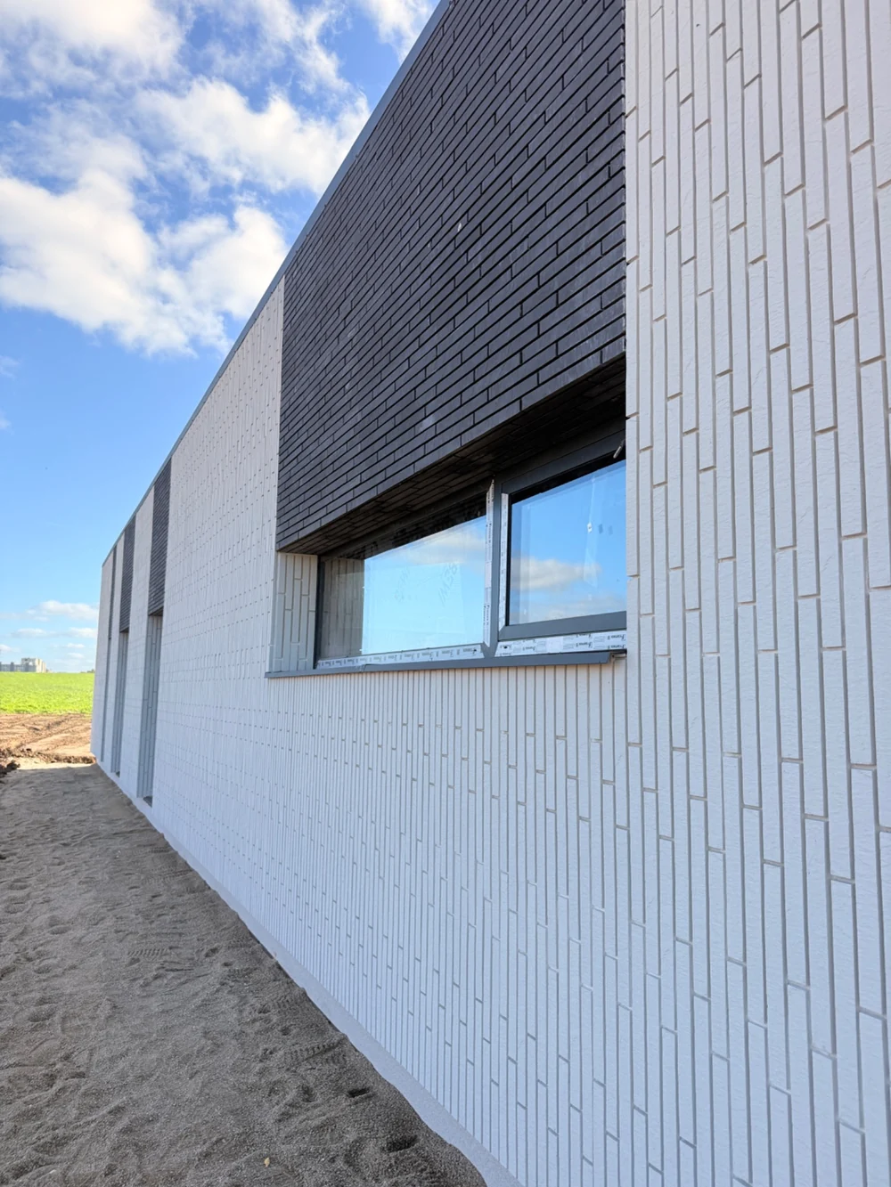 Completed brick-effect facade detail in a supplied project photograph